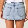 Mini gonna-pantalone in denim a vita bassa e sinuosa