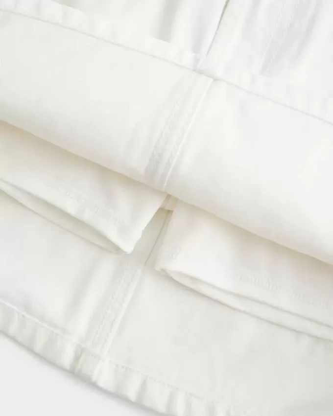 Mini gonna-pantalone in denim bianco a vita bassa