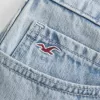 Mini gonna-pantalone in denim chiaro a vita bassa