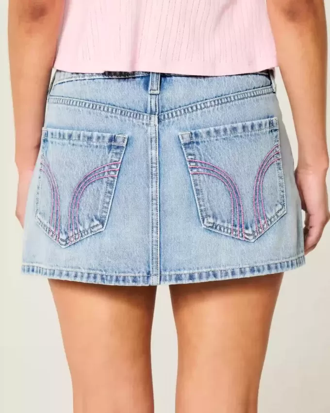 Mini gonna-pantalone in denim chiaro ricamato rosa a vita bassa