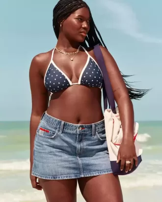 Mini gonna-pantalone in denim con bandiera ricamata e lavaggio medio a vita bassa
