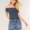 Mini gonna-pantalone in denim con bandiera ricamata e lavaggio medio a vita bassa