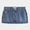 Mini gonna-pantalone in denim con bandiera ricamata e lavaggio medio a vita bassa