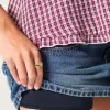 Mini gonna-pantalone in denim con borchie a vita bassa