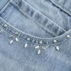 Mini gonna-pantalone in denim con borchie lavaggio chiaro
