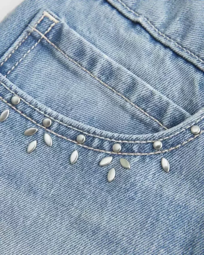 Mini gonna-pantalone in denim con borchie lavaggio chiaro