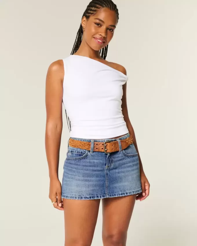 Mini gonna-pantalone in denim con fiocco ricamato a vita bassa e sinuosa