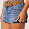 Mini gonna-pantalone in denim con fiocco ricamato a vita bassa e sinuosa