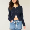 Mini gonna-pantalone in denim con lacci in pizzo