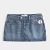 Mini gonna-pantalone in denim ricamato a vita bassa