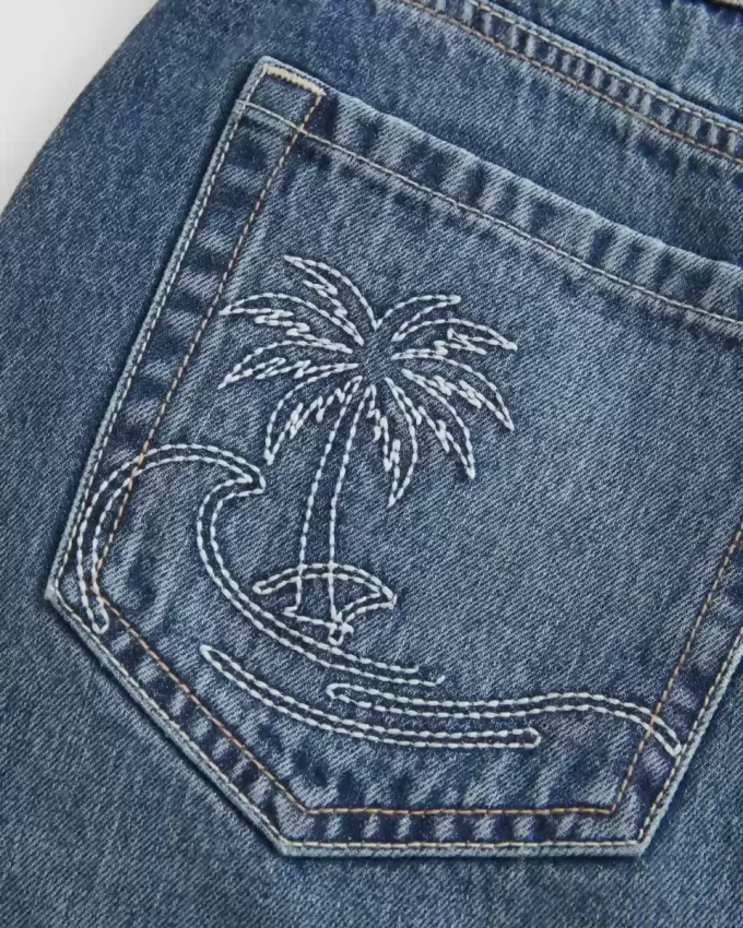 Mini gonna-pantalone in denim ricamato a vita bassa