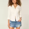 Mini gonna-pantalone in denim scuro strappato a vita bassa Mini gonna-pantalone in denim scuro strappato a vita bassa