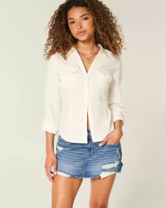 Mini gonna-pantalone in denim scuro strappato a vita bassa