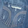 Mini gonna-pantalone in denim scuro strappato a vita bassa Mini gonna-pantalone in denim scuro strappato a vita bassa
