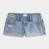 Mini shorts in denim ricamati a vita bassissima Mini shorts in denim ricamati a vita bassissima