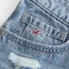 Mini shorts in denim ricamati a vita bassissima Mini shorts in denim ricamati a vita bassissima