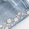 Mini shorts in denim ricamati a vita bassissima Mini shorts in denim ricamati a vita bassissima