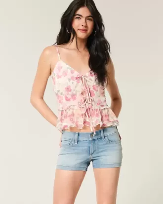 Pantaloncini corti in denim con borchie e lavaggio medio a vita bassa