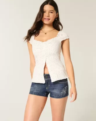 Pantaloncini corti in denim ricamati a vita bassa e lavaggio scuro