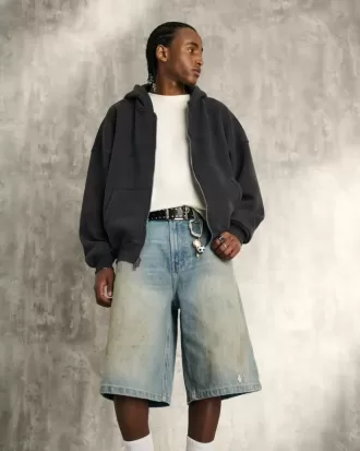Pantaloncini in denim super larghi con lavaggio medio ingrassato