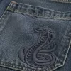 Pantaloncini larghi in denim con stampa serpente