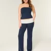 Pantaloni a zampa in maglia con risvolto in vita