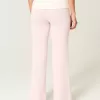 Pantaloni a zampa in maglia con risvolto in vita