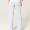 Pantaloni a zampa in maglia con risvolto in vita