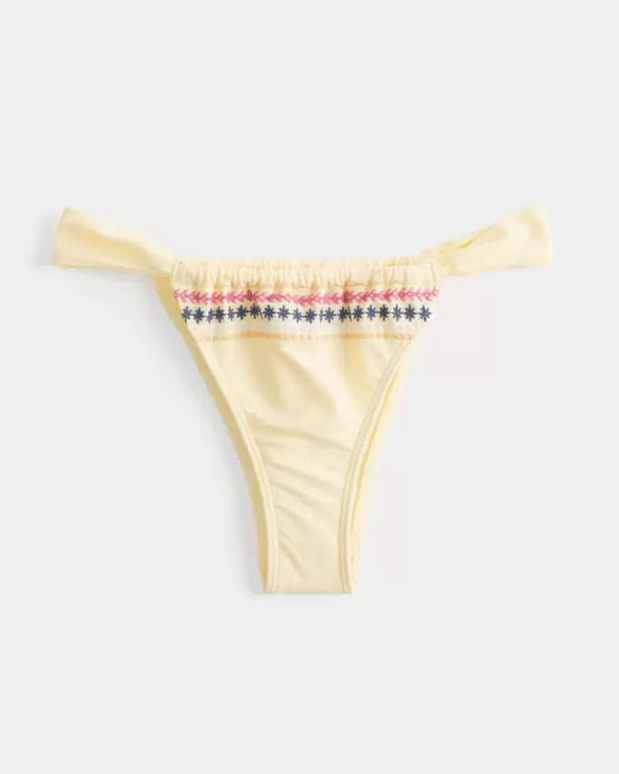 Slip bikini Cheekiest con sgambatura alta e cinturino laterale ricamato Slip bikini Cheekiest con sgambatura alta e cinturino laterale ricamato