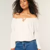 Top a maniche lunghe con spalle scoperte