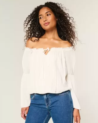 Top a maniche lunghe con spalle scoperte