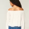 Top a maniche lunghe con spalle scoperte