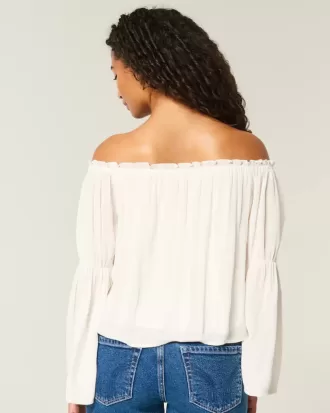 Top a maniche lunghe con spalle scoperte