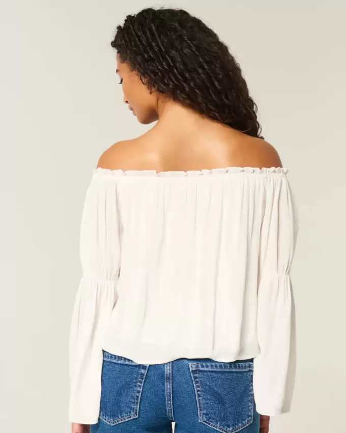 Top a maniche lunghe con spalle scoperte