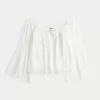 Top a maniche lunghe con spalle scoperte