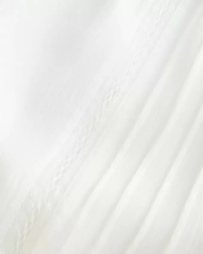 Top a maniche lunghe con spalle scoperte