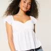 Top babydoll con maniche a sbuffo