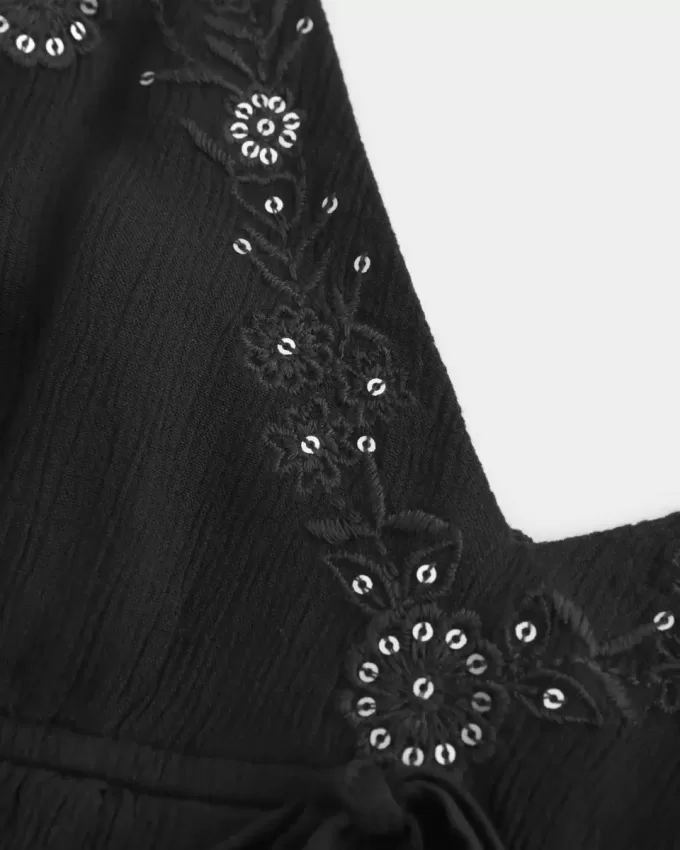 Top babydoll svolazzante e brillante increspato