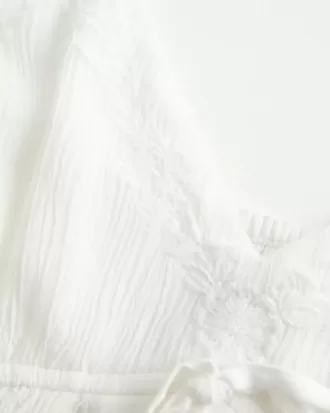Top babydoll svolazzante e brillante increspato