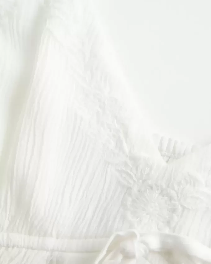 Top babydoll svolazzante e brillante increspato