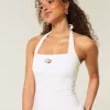 Top con scollo all’americana e grafica con perline Top con scollo all’americana e grafica con perline